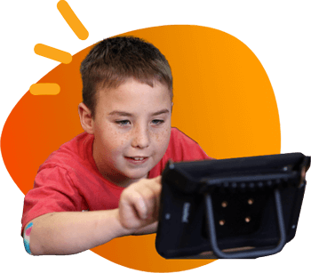 A boy using a QuickTalker Freestyle tablet