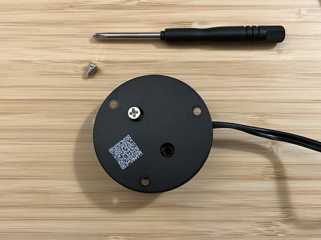 Upside down Specs switch with round black plastic base showing, 1 screw partially removed and 1 screw completely removed