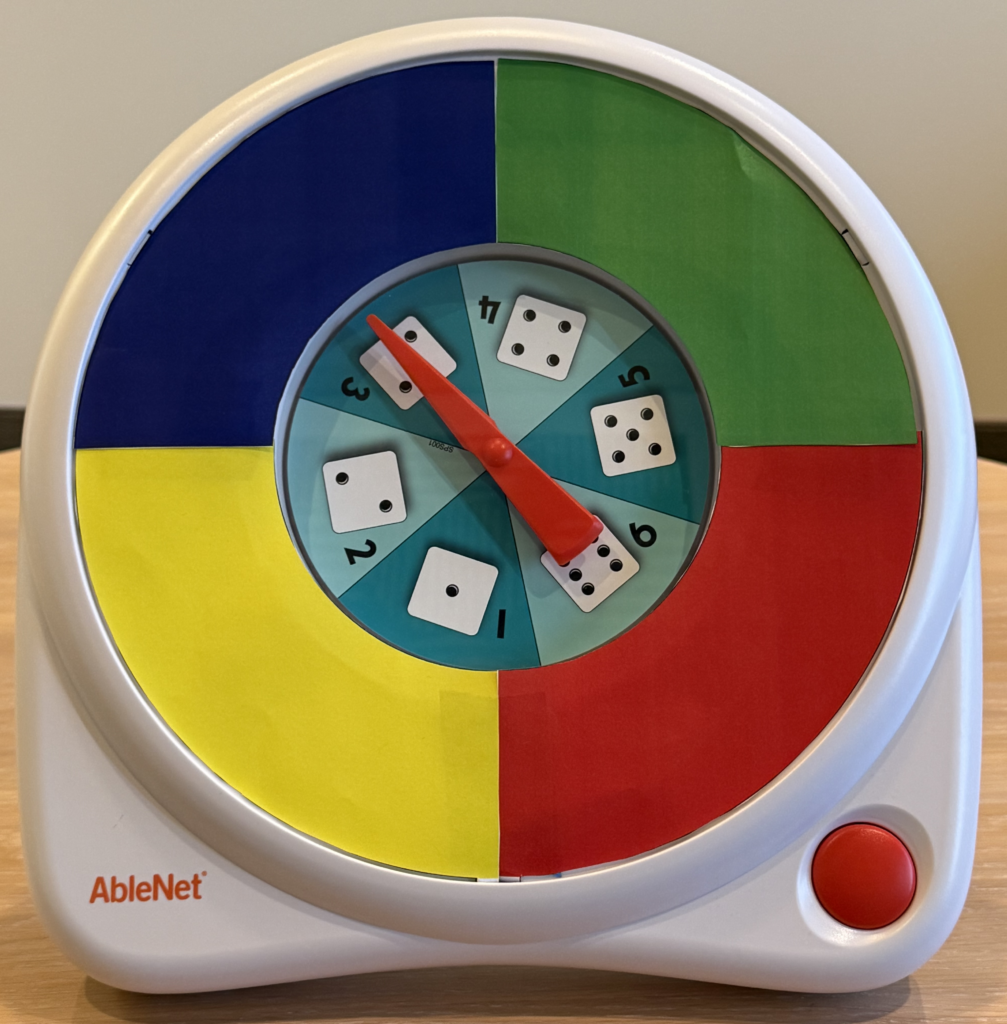 The AbleNet All-Turn-It Spinner with a four-color,  blue, green, red, and yellow, overlay.