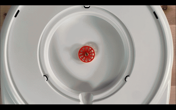 An animated GIF showing the placement of the inner disk, spinner, and clear plastic cover.