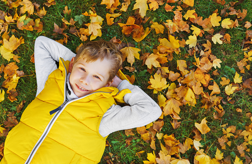 Child Laying In Leaves