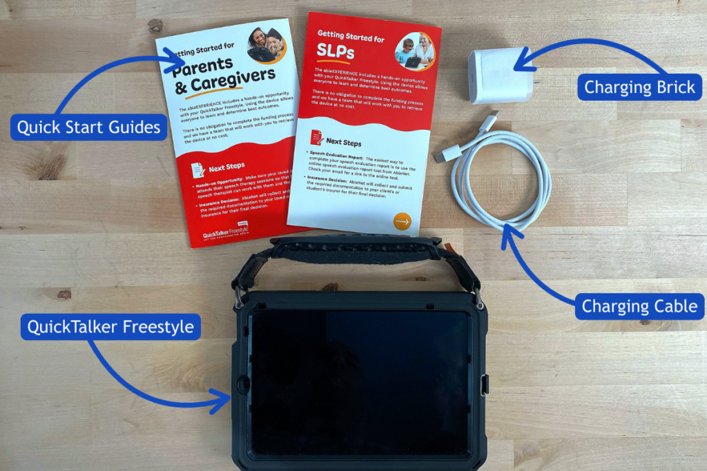 All of the items in your box including: Quick Start Guides, Charging block and cable, and the QuickTalker Freestyle.
